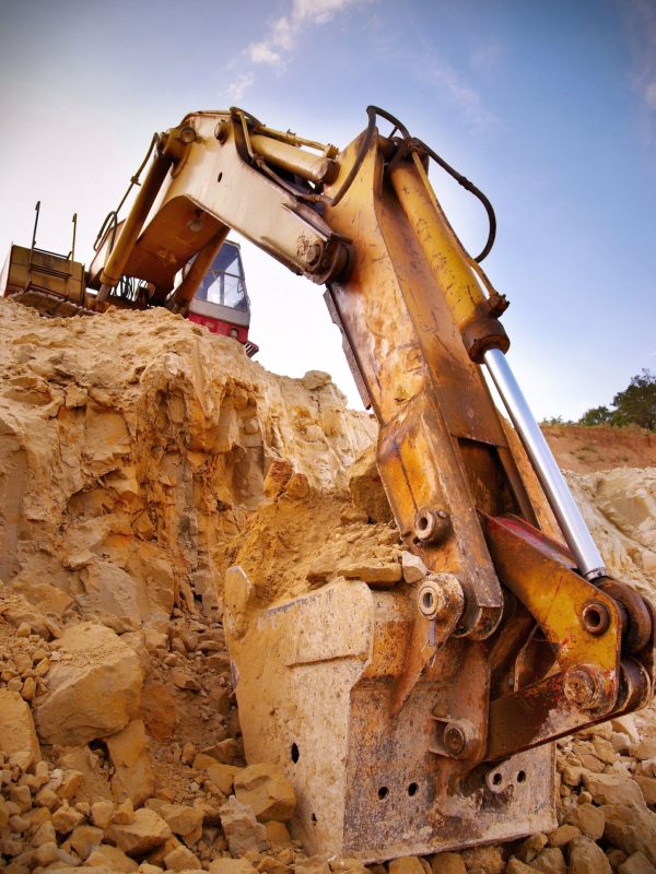 Close-up of a construction site excavator at sunset